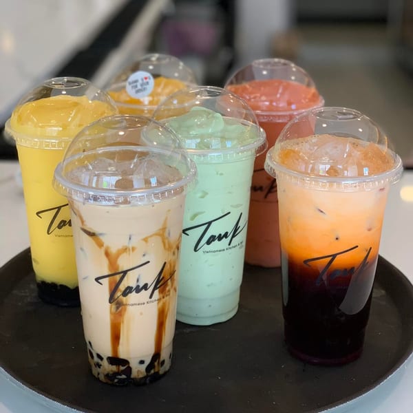 Six colorful Vietnamese drinks from Tank Noodle, including boba, smoothies, and iced tea.